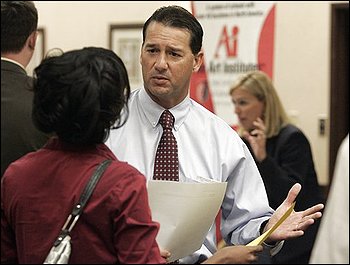 Recruiter for Waffle House, Tim Broadwater, center, talks with a job fair attendee in Richmond, Va., Friday, Oct. 2, 2009. The unemployment rate rose to 9.8 percent in September, the highest since June 1983, as employers cut far more jobs than expected.(AP Photo/Steve Helber)